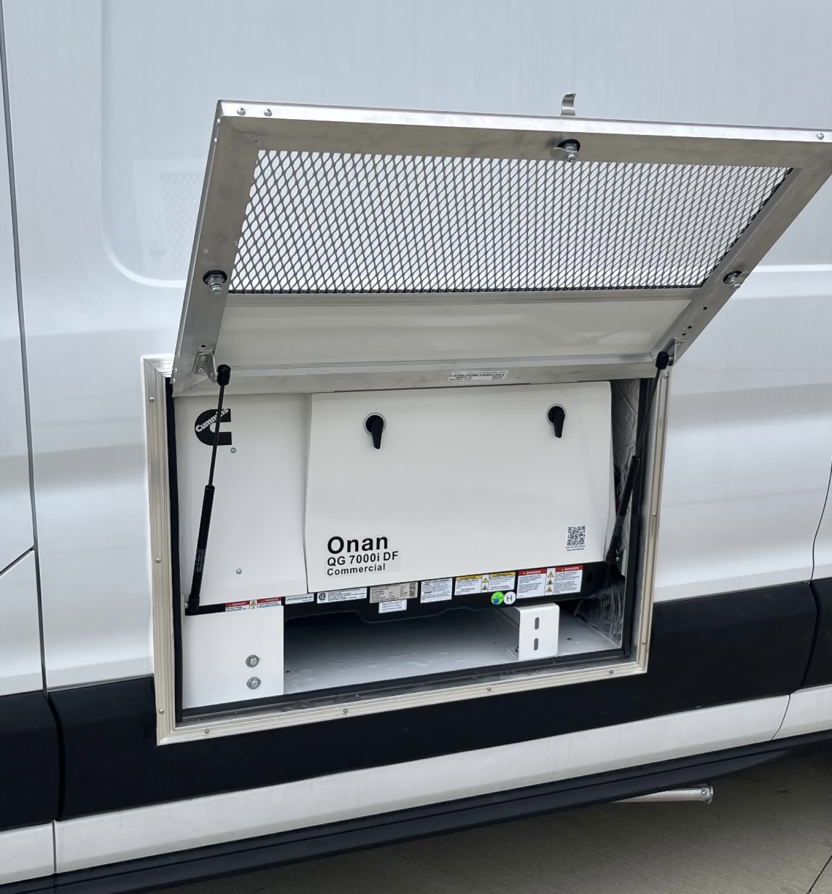 Onan commercial generator mounted in an access compartment on the exterior of a work van